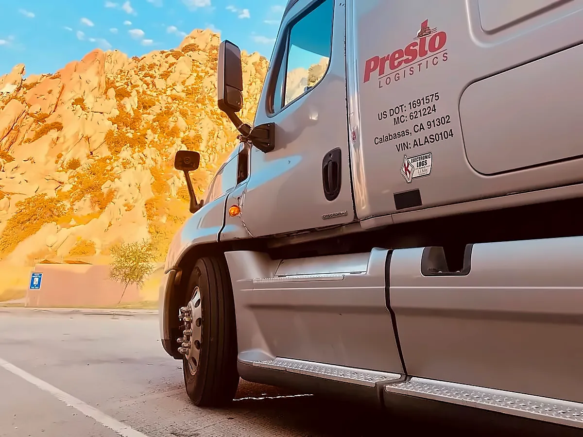 Side of a Presto Logistics truck cab showing the Presto logo, USDOT 1691575 and MC 621224